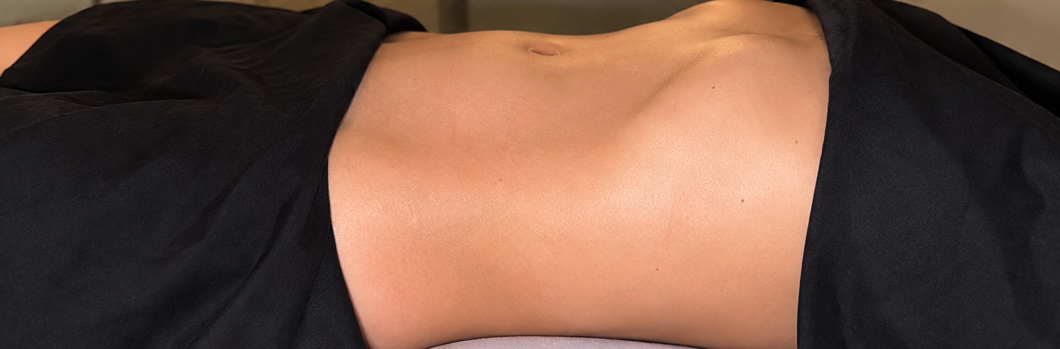 Draped client abdomen after lymphatic drainage massage